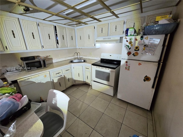 kitchen featuring sink, light tile patterned floors, and white appliances