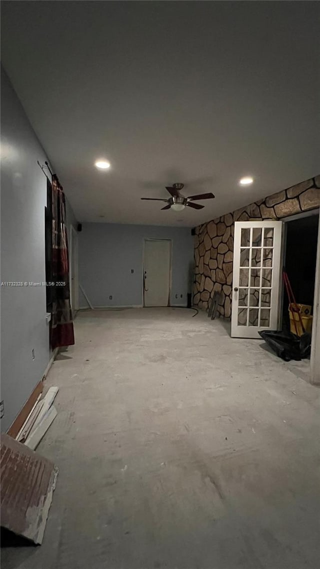 unfurnished living room featuring ceiling fan