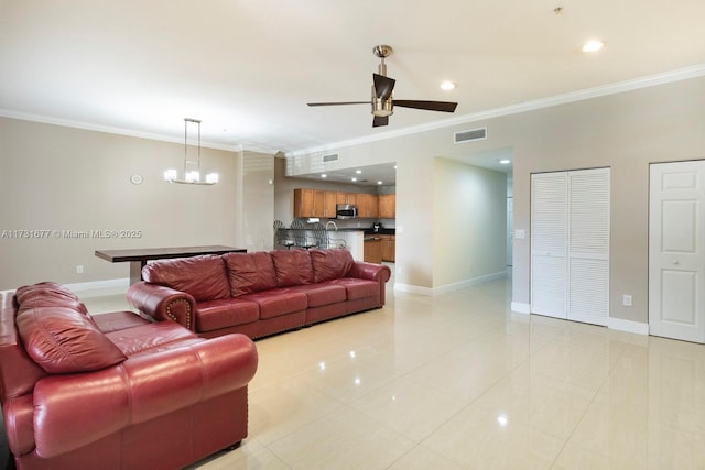 tiled living room featuring ceiling fan with notable chandelier and ornamental molding