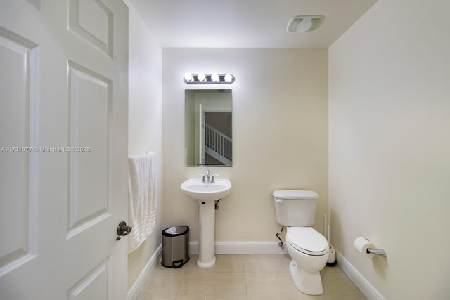 bathroom featuring sink, tile patterned floors, and toilet