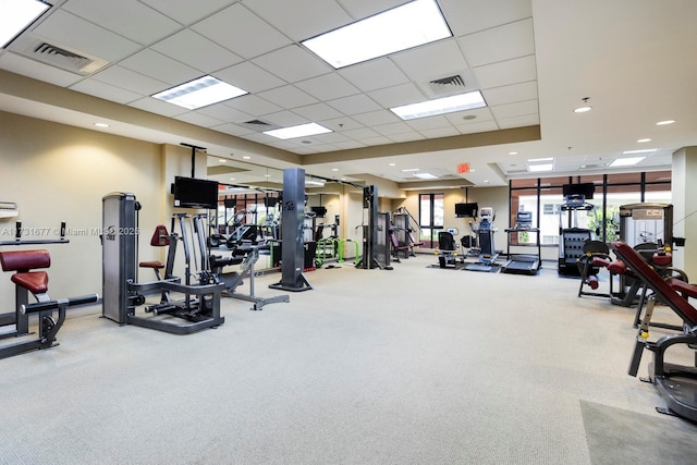 gym featuring carpet floors and a paneled ceiling