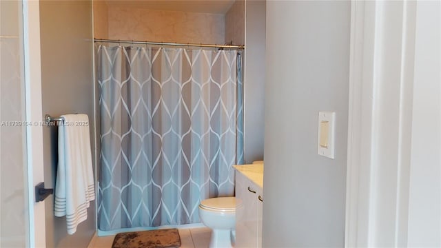 bathroom featuring vanity, tile patterned flooring, curtained shower, and toilet