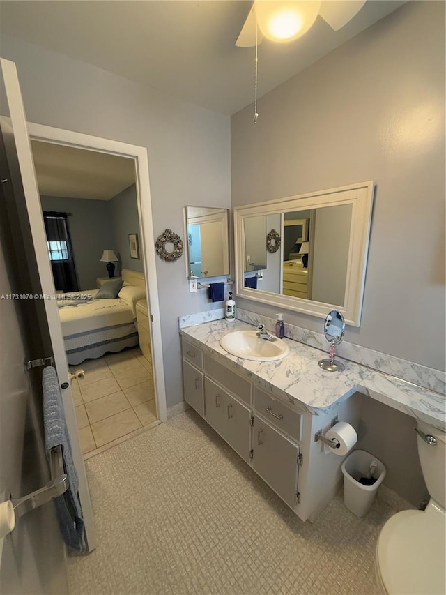 bathroom with toilet, vanity, and ensuite bathroom