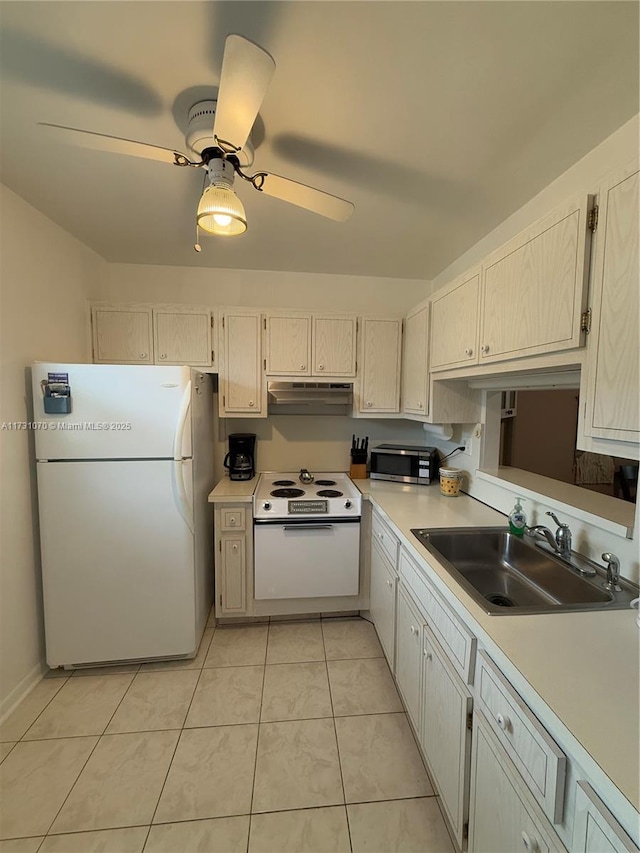 kitchen featuring ceiling fan, under cabinet range hood, white appliances, a sink, and light countertops