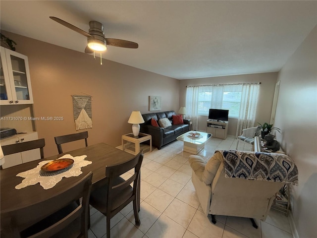 living area featuring a ceiling fan and light tile patterned flooring