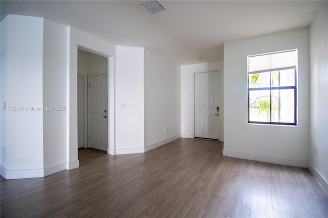 unfurnished room featuring dark hardwood / wood-style flooring