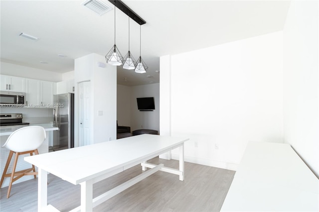 dining space with light wood-type flooring