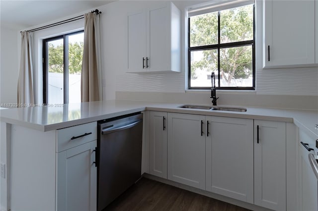 kitchen featuring dishwasher, sink, white cabinets, and kitchen peninsula