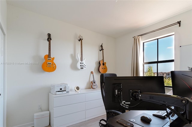 office area with light hardwood / wood-style floors