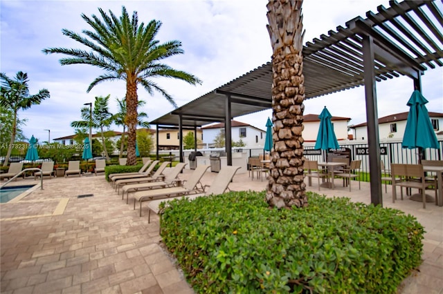 view of community with a pergola and a patio