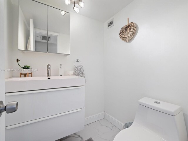 bathroom with vanity and toilet