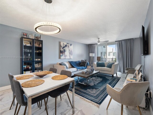 dining area with ceiling fan and a textured ceiling