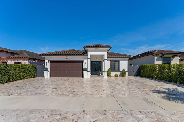 mediterranean / spanish-style home with a garage