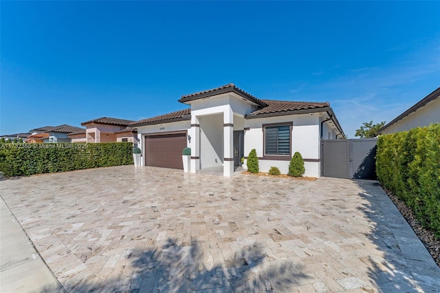 mediterranean / spanish-style home with a garage