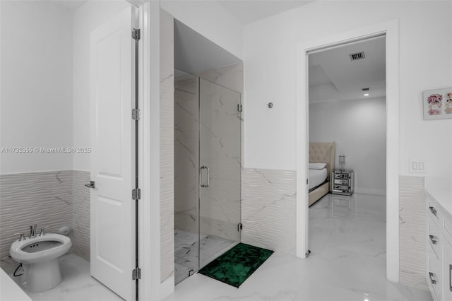 bathroom with a bidet, vanity, and walk in shower