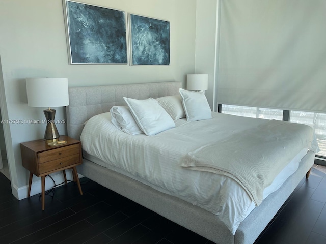 bedroom with dark hardwood / wood-style flooring