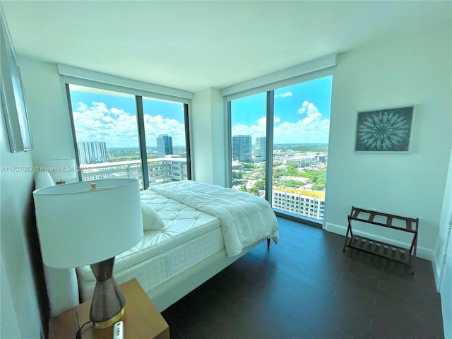 bedroom with access to outside and a wall of windows