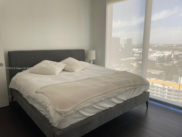 bedroom with wood-type flooring and access to outside