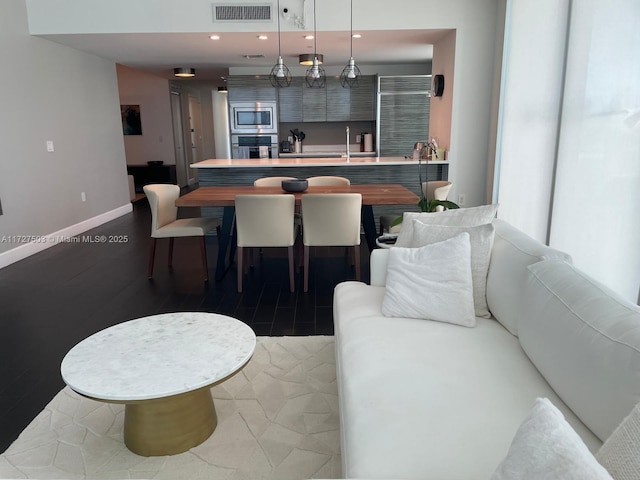 dining area featuring wood-type flooring and sink