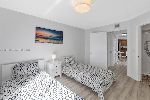 bedroom with a closet and light hardwood / wood-style flooring