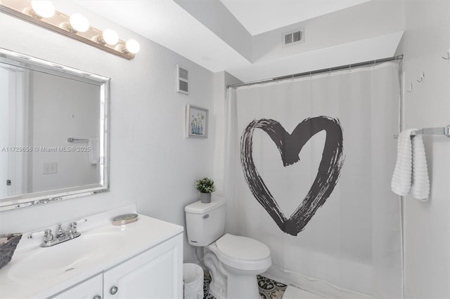 bathroom featuring vanity, walk in shower, and toilet