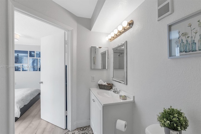 bathroom featuring vanity, hardwood / wood-style floors, and toilet