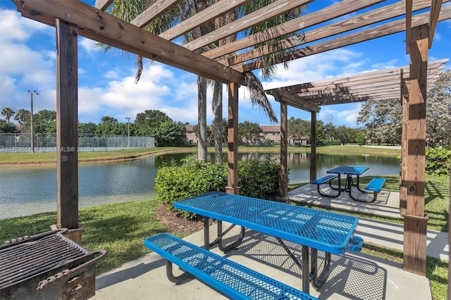 view of patio featuring a water view and a pergola