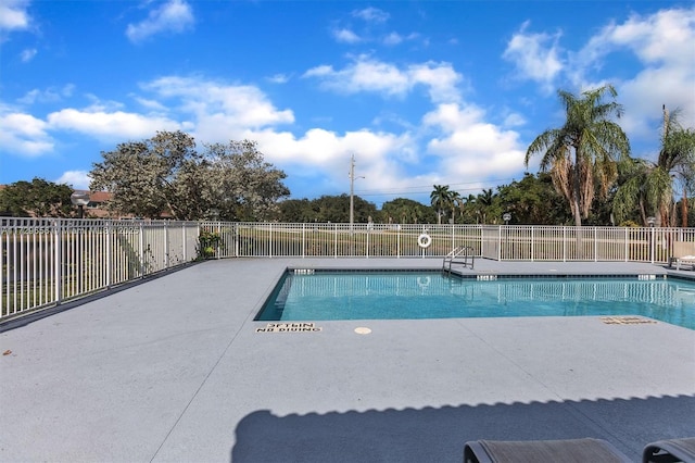 view of swimming pool with a patio area