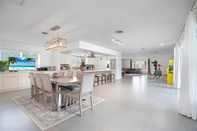 dining space featuring light tile patterned floors and a wealth of natural light