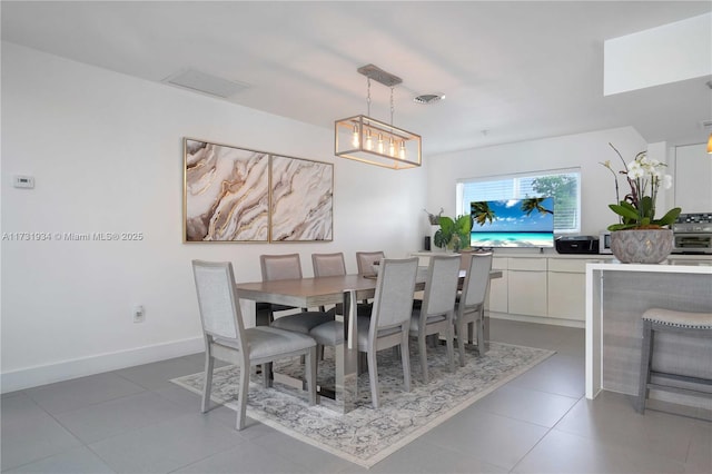 dining space with tile patterned flooring