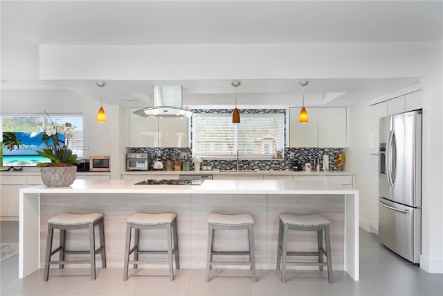 kitchen with white cabinetry, sink, a breakfast bar area, and appliances with stainless steel finishes