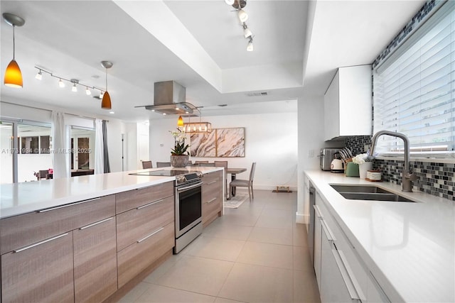 kitchen with sink, white cabinetry, island range hood, decorative light fixtures, and stainless steel electric stove