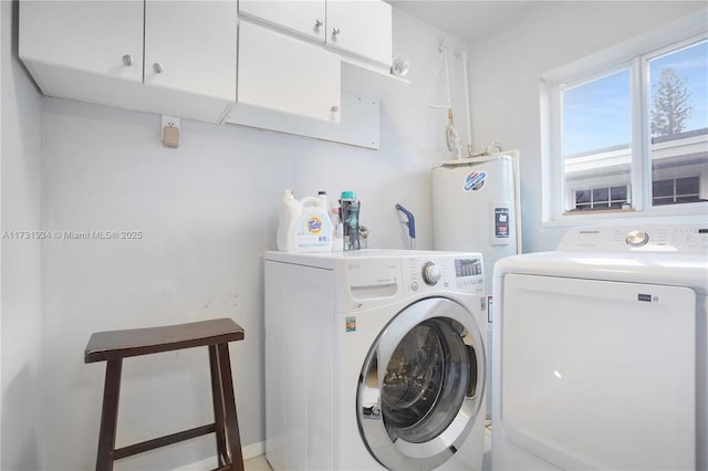 laundry area with cabinets and washing machine and clothes dryer