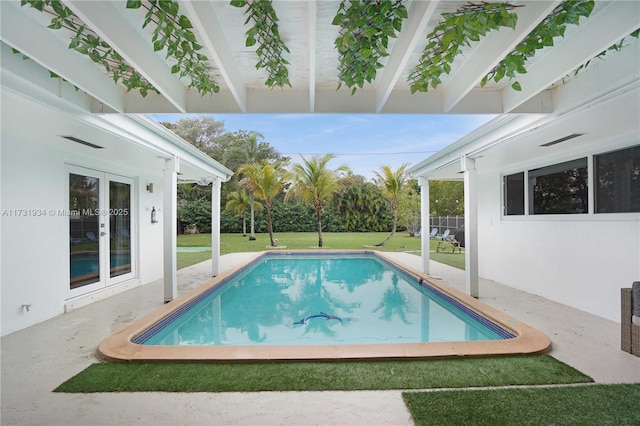 view of pool with a yard and a patio area