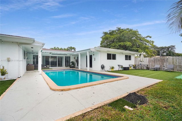 view of pool featuring a patio and a lawn