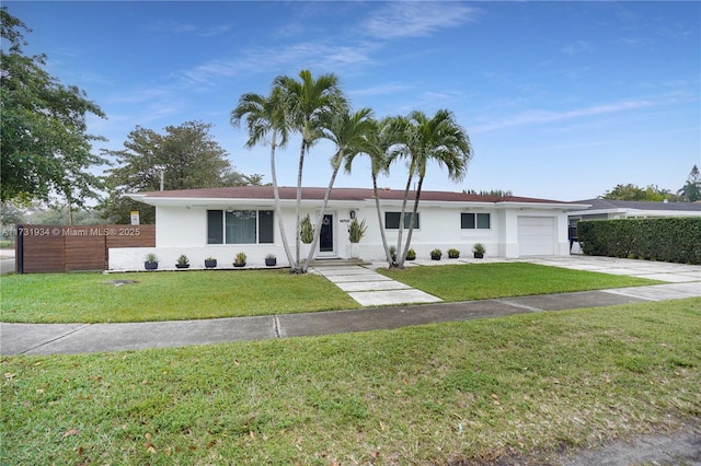 ranch-style home with a garage and a front lawn