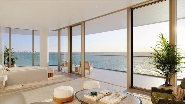 sunroom featuring a water view