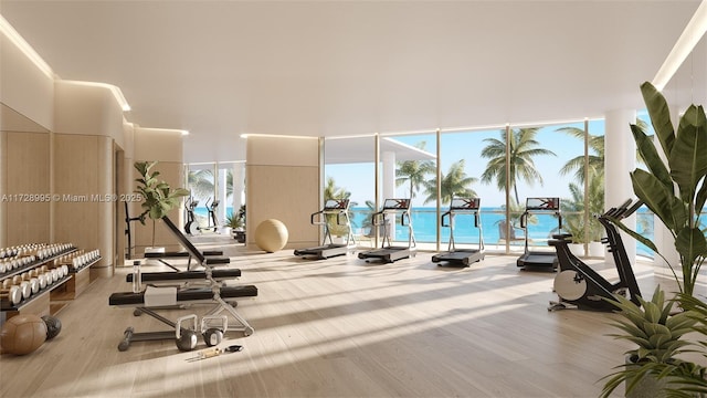 workout area with floor to ceiling windows, a water view, and light wood-type flooring