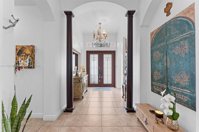 tiled foyer with ornate columns and french doors