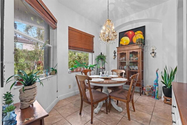 tiled dining space with an inviting chandelier