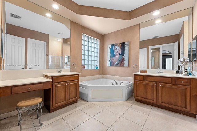 bathroom featuring tile patterned flooring, vanity, and a bathtub