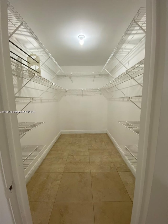 spacious closet with tile patterned flooring