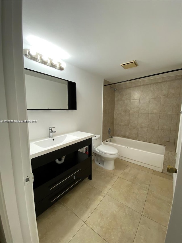 full bathroom featuring tiled shower / bath combo, vanity, tile patterned floors, and toilet