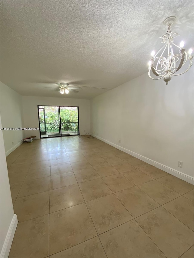 spare room with ceiling fan with notable chandelier, a textured ceiling, and light tile patterned floors