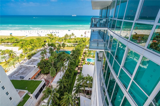 balcony with a water view and a beach view