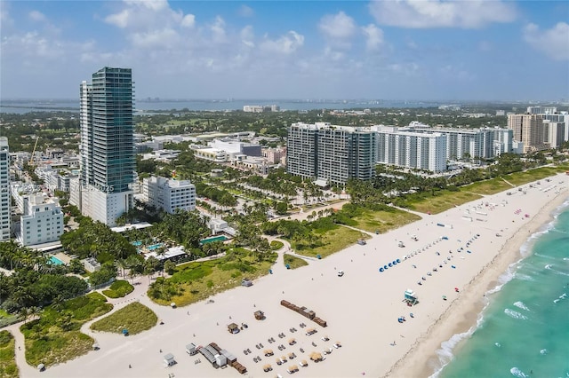 birds eye view of property with a view of the beach and a water view