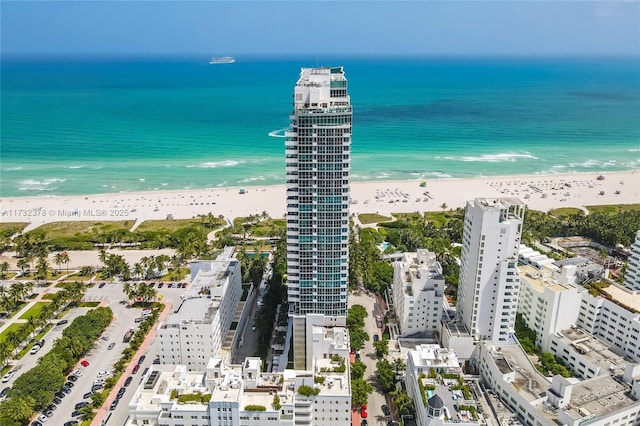 drone / aerial view featuring a view of the beach and a water view