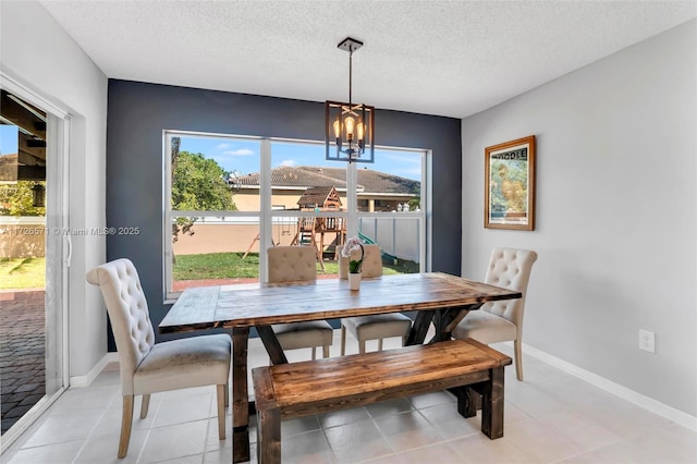 tiled dining space with an inviting chandelier, a wealth of natural light, and a textured ceiling