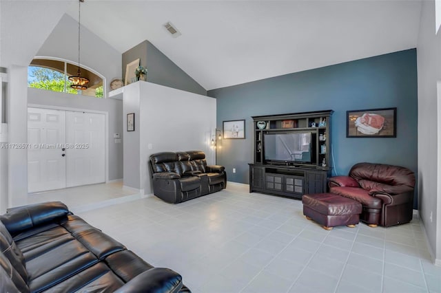 living room featuring a notable chandelier, high vaulted ceiling, and light tile patterned floors