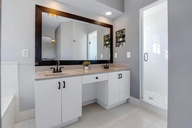 bathroom featuring vanity, plus walk in shower, and tile patterned flooring